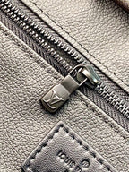 Louis Vuitton blue monogram leather belt bag close-up of metal zipper pull and stitched leather