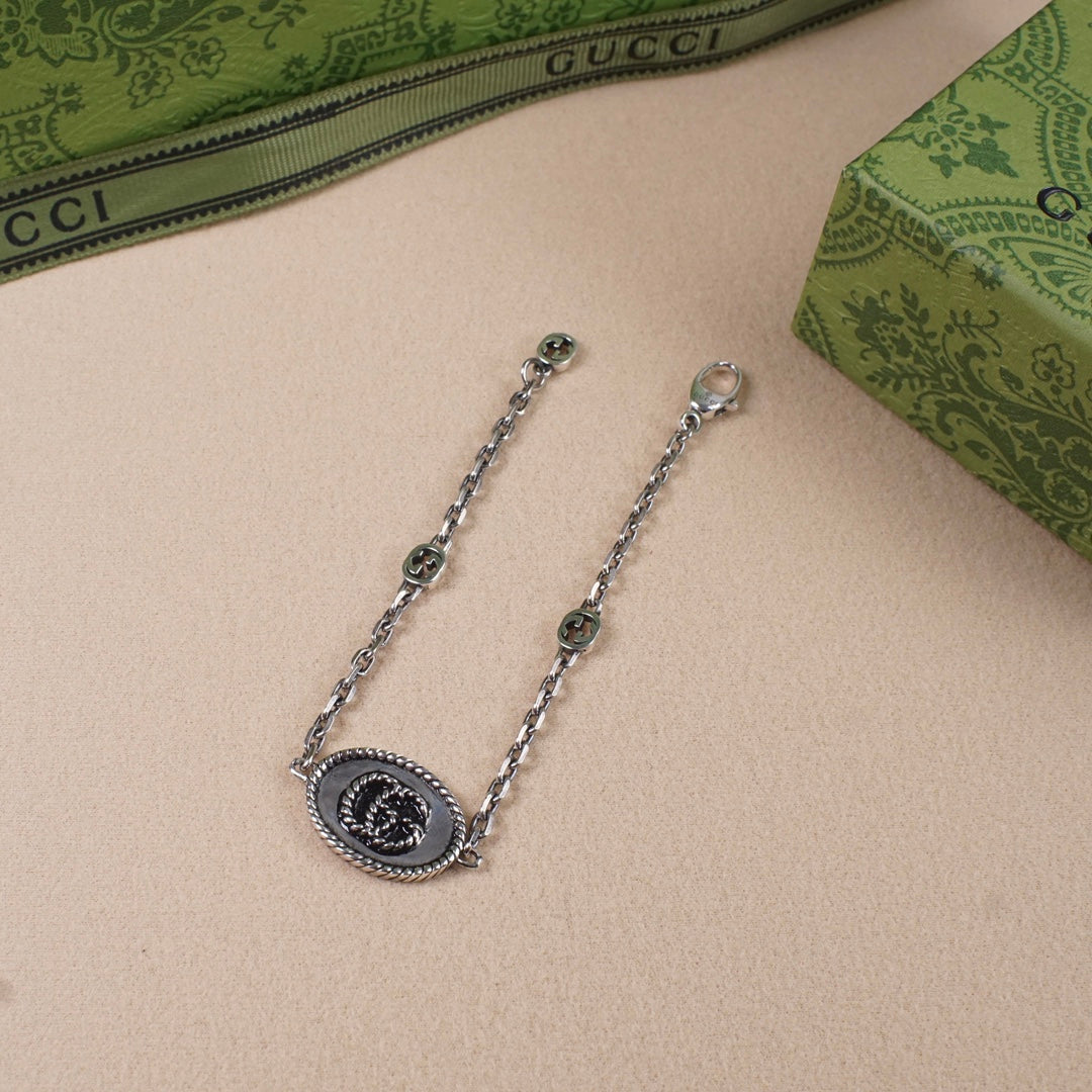 Gucci bracelet with oval logo charm, silver-tone chain and end rings
