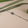 Gucci bracelet with oval logo medallion, silver-tone link chain and clasp