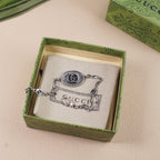Gucci bracelet in box, oval logo medallion on silver-tone chain