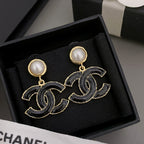 Chanel-style drop earrings with black enamel CC design and round pearl stud tops