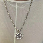 Silver-tone GG pendant on chain necklace with round interlocking emblem