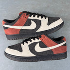 Pair of black, white, and rust-orange low-top sneakers with Nike swoosh and laces