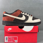 Black, white, and orange low-top sneakers with swoosh and black laces