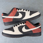 Black, white, and orange-brown low-top sneakers with swoosh, laces, and textured panels