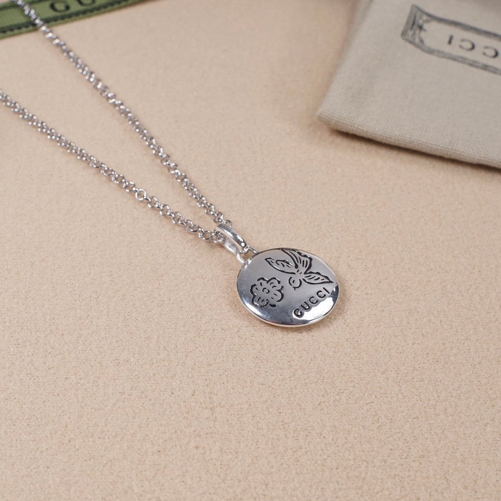 Silver heart pendant necklace with flower and Gucci logo engraving, on chain