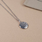 Silver heart pendant necklace with engraved script and Gucci logo on chain