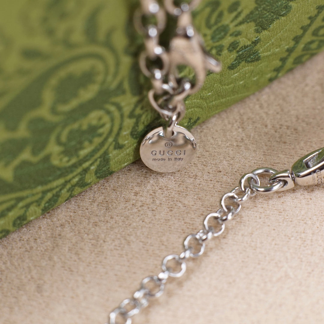 Silver Gucci pendant necklace with clasp detail and engraved Gucci text