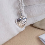 Silver heart pendant necklace with floral script engraving and Gucci logo