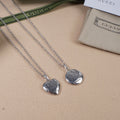 Silver heart pendant necklaces with engraved Gucci logo, on chain detail set