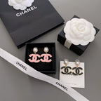 Pair of Chanel-style earrings with black enamel CC drops and pearl stud tops