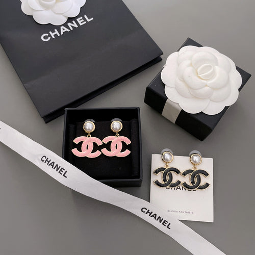 Pair of Chanel-style earrings with black enamel CC drops and pearl stud tops