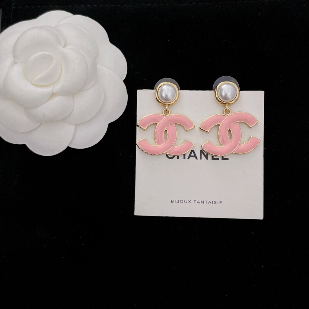 Pair of Chanel-style earrings with pink CC logo dangle charms and pearl stud tops