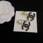 Chanel-style earrings with black enamel CC drop charms and round pearl stud tops