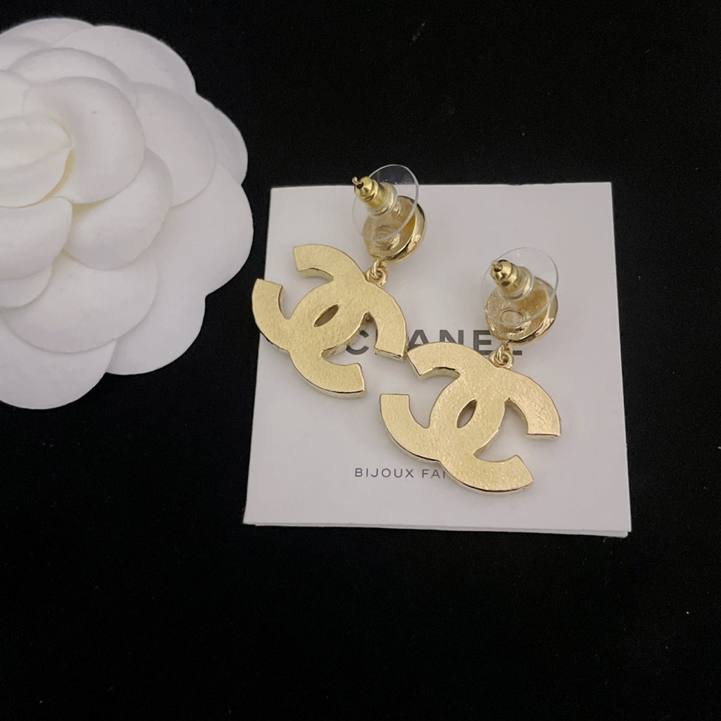 Pair of Chanel-style hoop earrings with gold-tone dangling logo charms and pearl accents