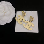Pair of Chanel-style hoop earrings with gold-tone dangling logo charms and pearl accents