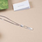 Gucci necklace pendant with silver-tone bar and logo on a chain