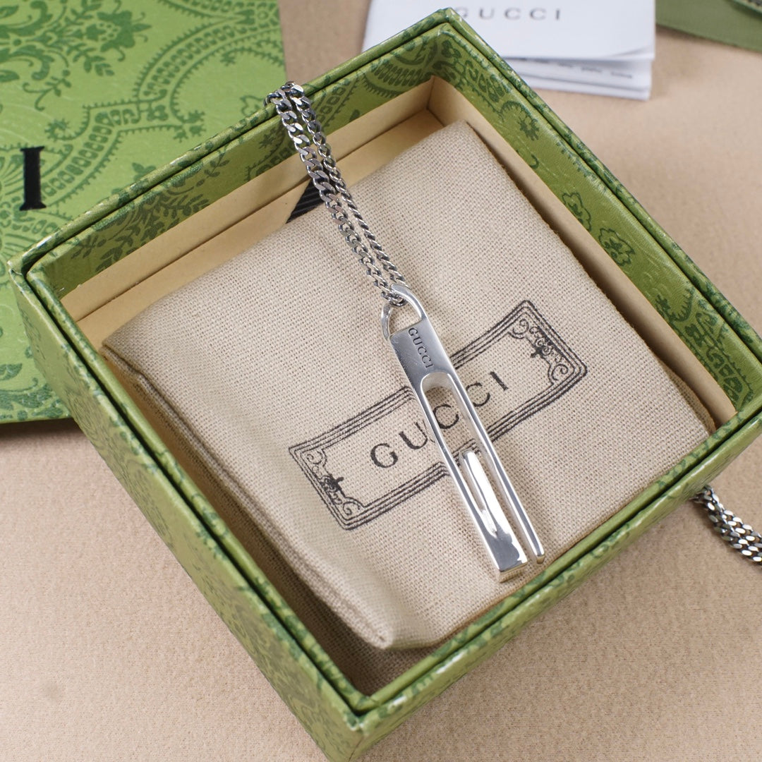 Gucci necklace pendant on a chain inside a green gift box