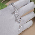 Silver-tone beaded bracelet with circular pendant and slim bar charm
