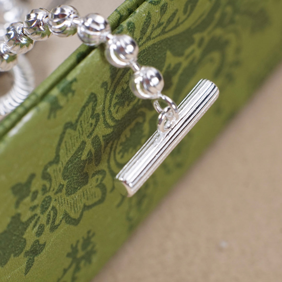 Silver-tone bar pendant on bead bracelet chain