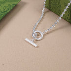 Silver-tone necklace with circular ring clasp and slim bar charm