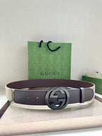 Gucci belt with dark brown leather strap and round silver GG logo buckle