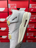Light gray Air Jordan 4 sneaker side view with quilted upper, cream midsole and visible Air unit