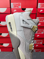 Light gray Air Jordan 4 sneaker heel and side with textured paneling, cream sole and yellow tabs