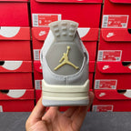 Light gray Air Jordan 4 sneaker heel with gold Jumpman logo and cream outsole
