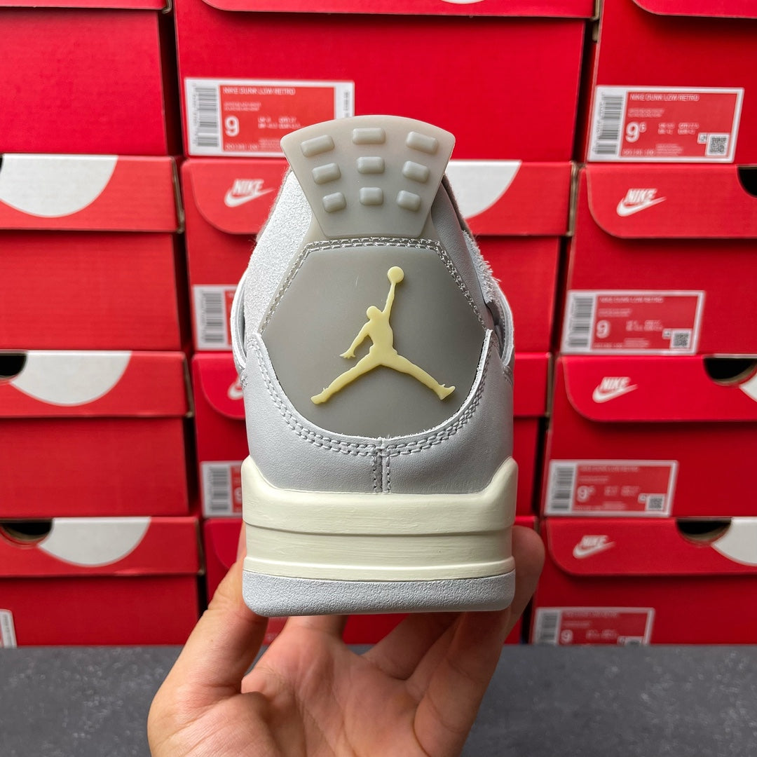Light gray Air Jordan 4 sneaker heel with gold Jumpman logo and cream outsole