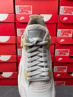 Light gray Air Jordan 4 sneaker top view with lace-up closure and textured collar