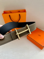 Leather belt with textured taupe strap and gold double-prong buckle