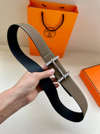 Taupe leather belt on black underside strap with silver double-prong buckle