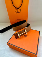 Hermes leather belt in tan with silver buckle, paired with dark strap interior