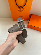 Gray leather belt with silver double-bar buckle and punched adjustment holes