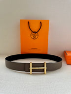 Gray leather belt with gold-toned double-bar buckle, shown flat on surface