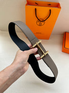 Gray leather belt with gold-toned double-bar buckle and black underside