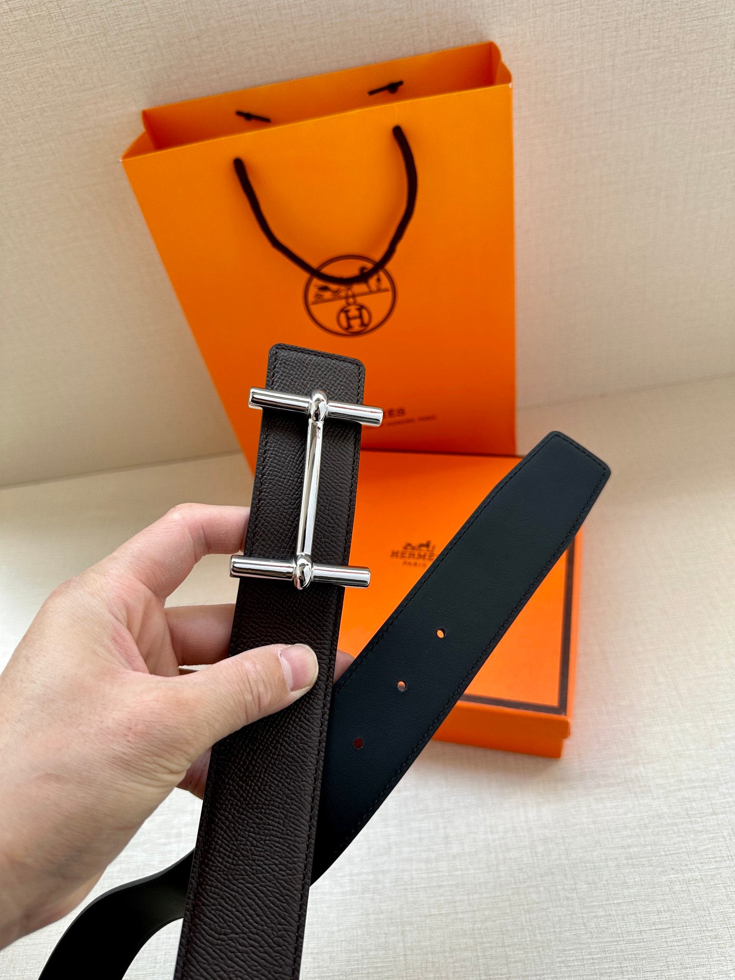 Hermes belt, dark leather strap held up with silver-tone double-bar buckle