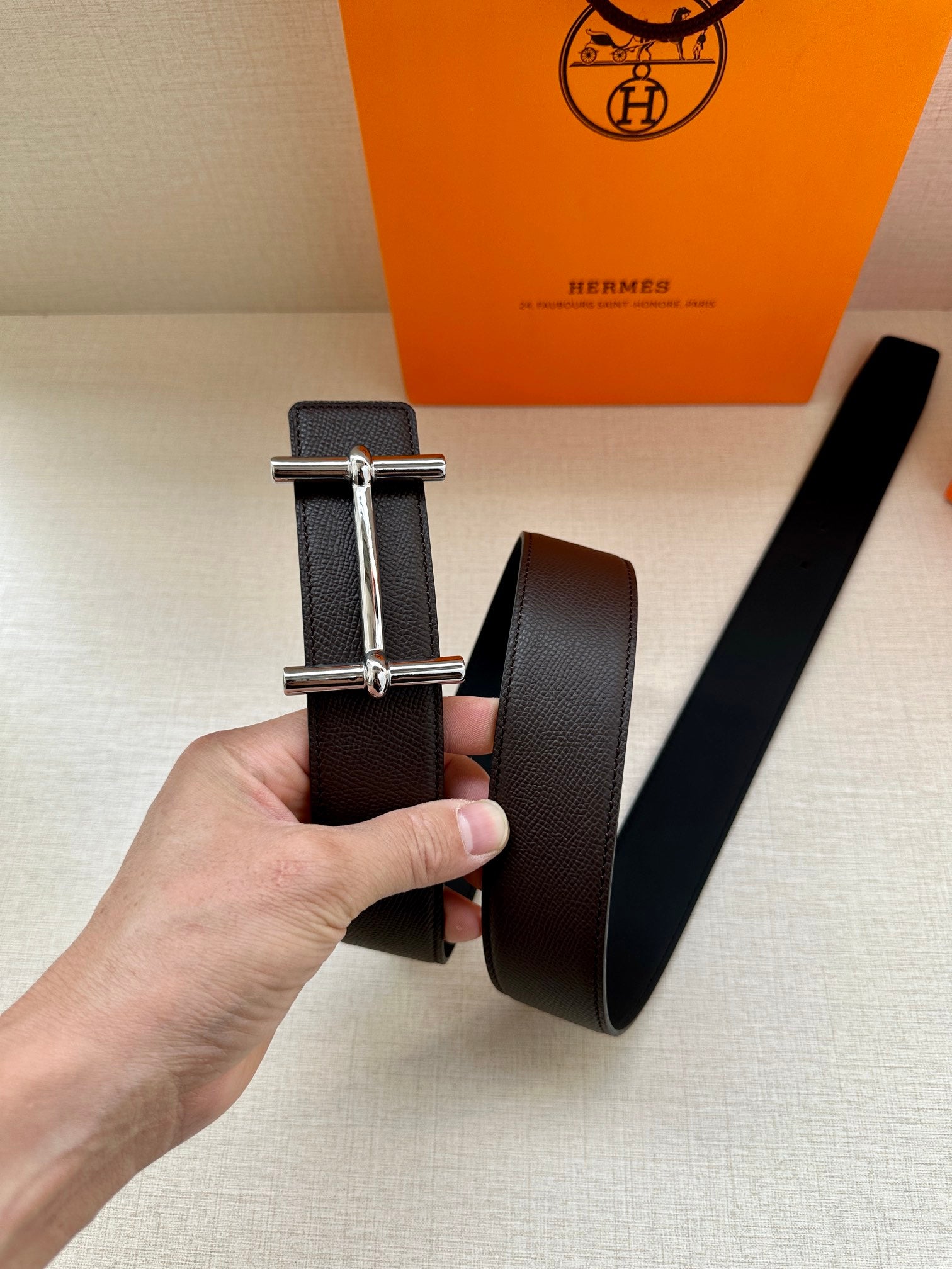 Hermes belt, dark leather strap with silver-tone double-bar buckle