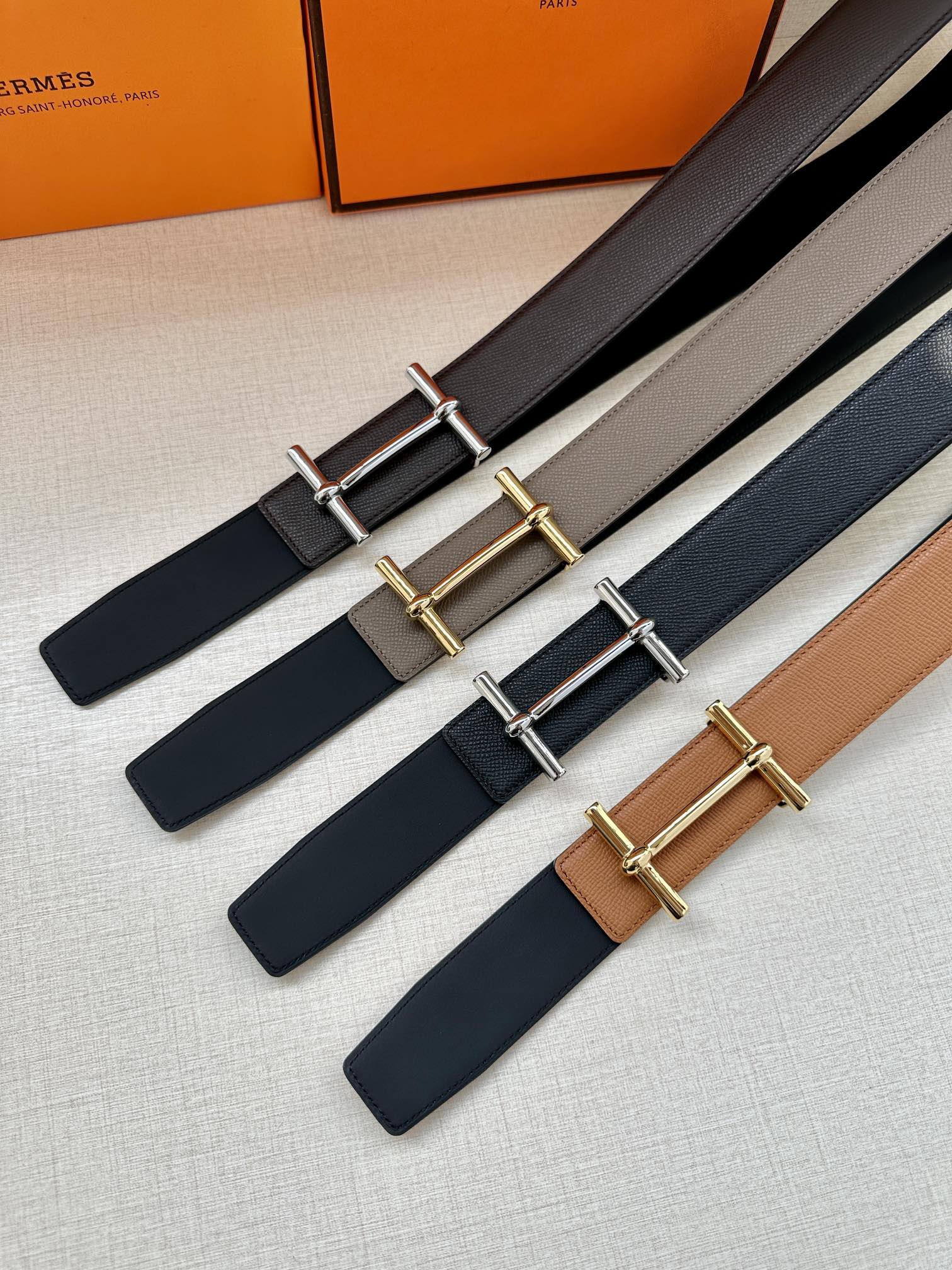 Hermes belts set, dark leather straps with silver- and gold-tone double-bar buckles