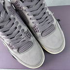Pair of grey Air Jordan 4 sneakers with lace-up fronts and mesh windows