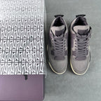 Grey Air Jordan 4 sneakers in pair, angled side view with lace-up uppers