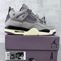 Grey suede Air Jordan 4 sneaker with black outsole and light yellow midsole