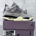 Grey suede Air Jordan 4 sneaker with black outsole and light yellow midsole
