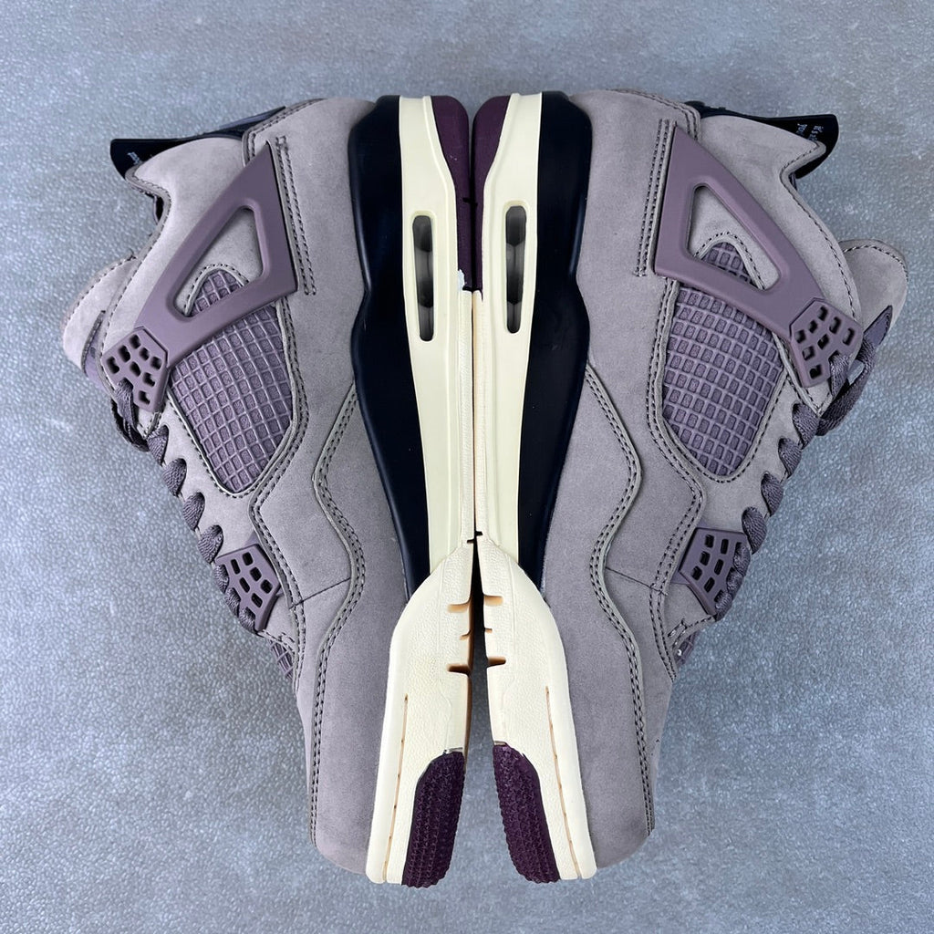 Grey Air Jordan 4 sneaker top view with laces, mesh panels, and side cutouts