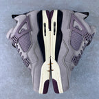 Grey Air Jordan 4 sneaker top view with laces, mesh panels, and side cutouts
