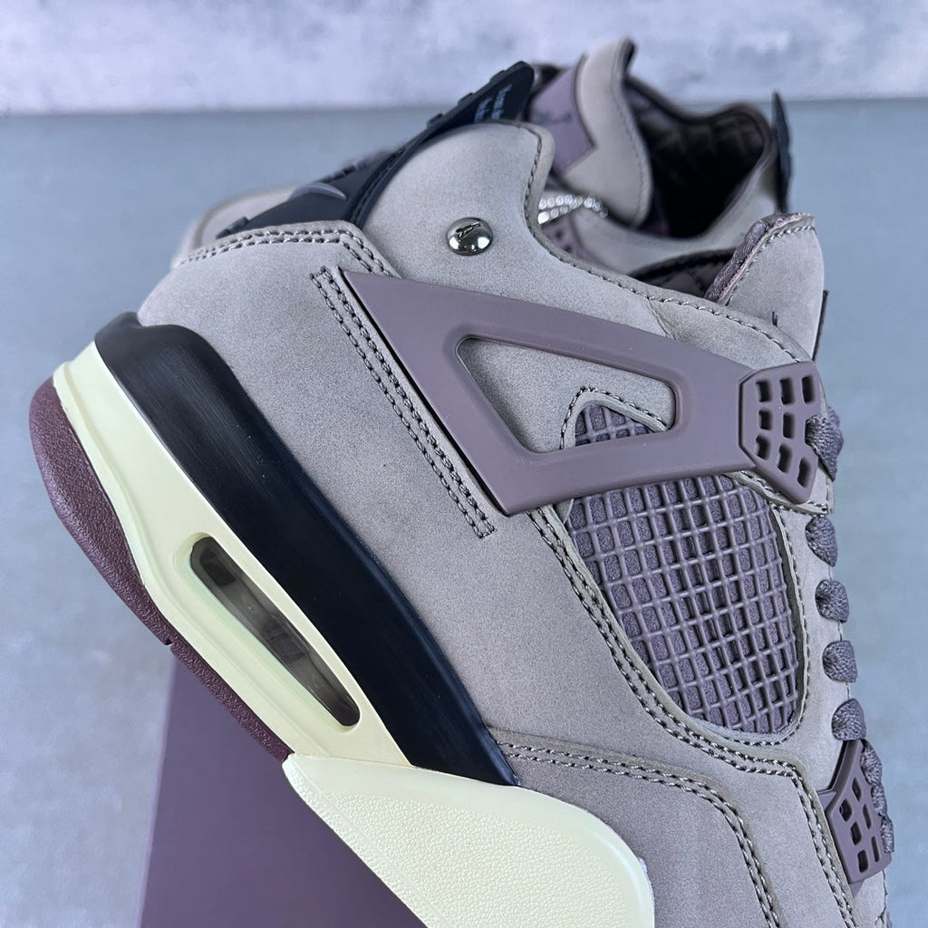 Grey Air Jordan 4 sneaker profile with lace-up front and mesh quarter panel