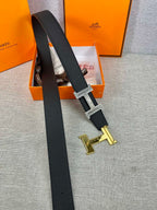 Dark leather belt with silver-tone square buckle and gold-tone spare buckle pieces