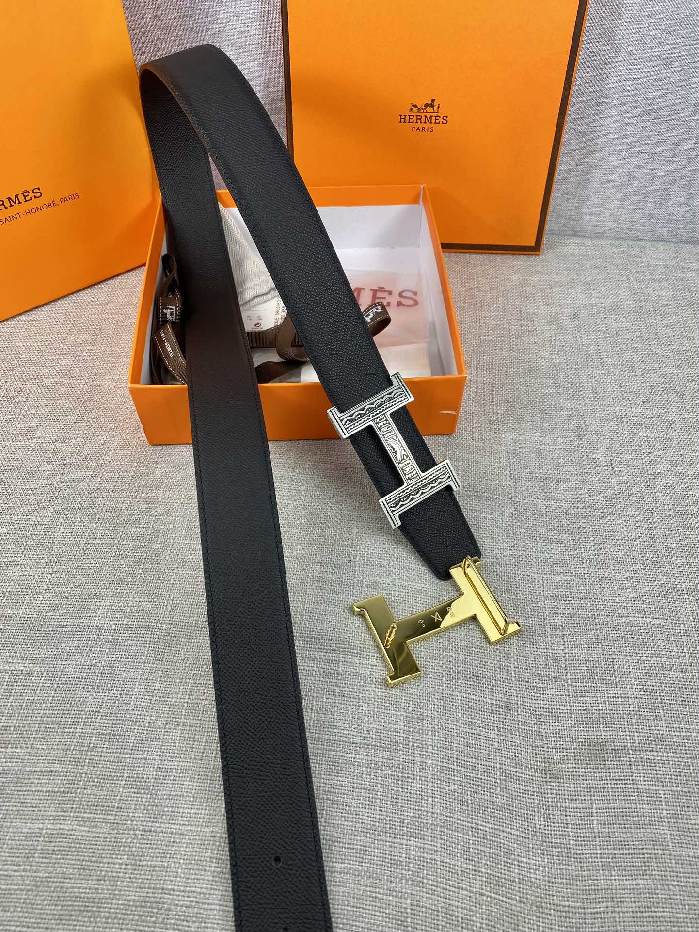 Dark leather belt with silver-tone square buckle and gold-tone spare buckle pieces