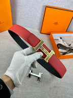 Red leather belt with black underside and silver engraved H buckle detail